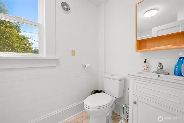 a room with table chairs and windows