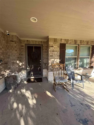 a building outdoor space with patio couch and a potted plant