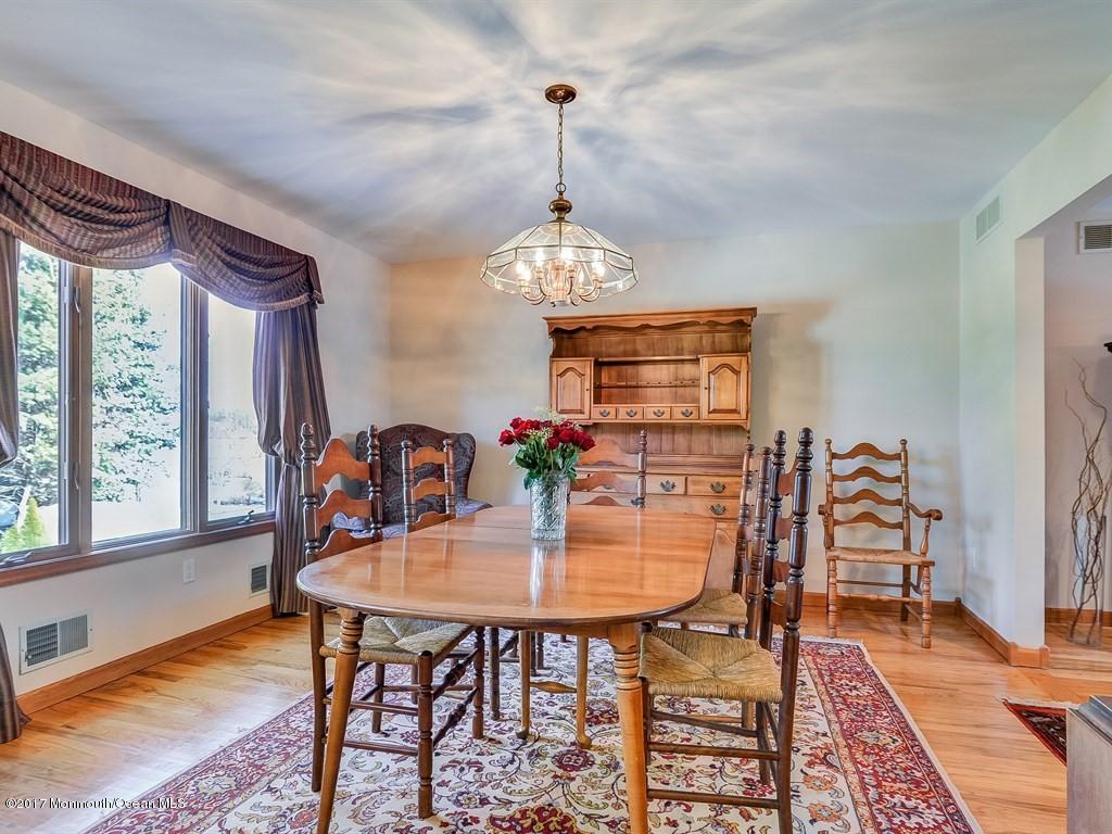 778 Adelphia Road Freehold, NJ 07728 - Photo 9 of 40 a dining room with furniture a chandelier and wooden floor