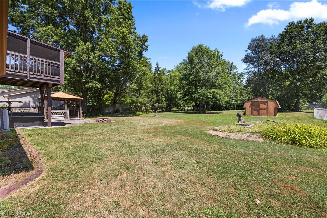 2565 Abbe Road North Sheffield Lake, OH 44054 - Photo 28 of 32 View of yard with a gazebo, a shed, and an outdoor fire pit