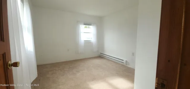 a view of an empty room and a window