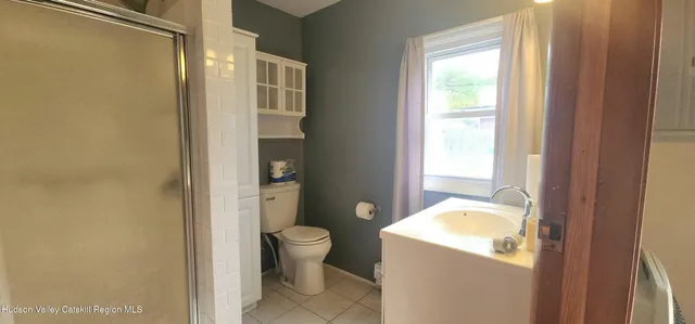 a tall tree in middle of the park