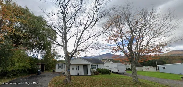 a view of house with a yard