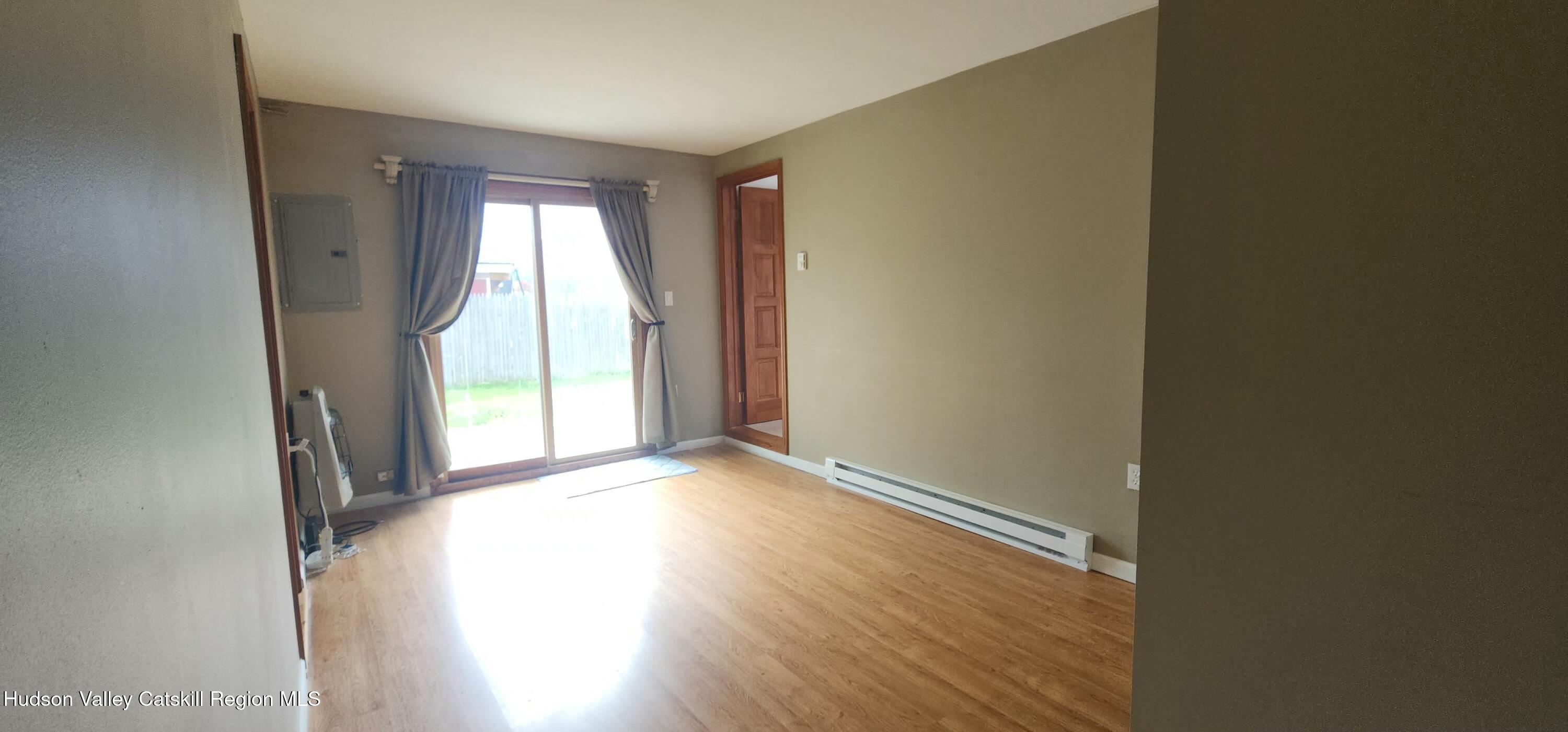 231 Stone Bridge Road Cornwallville, NY 12418 - Photo 10 of 18 an empty room with wooden floor and windows