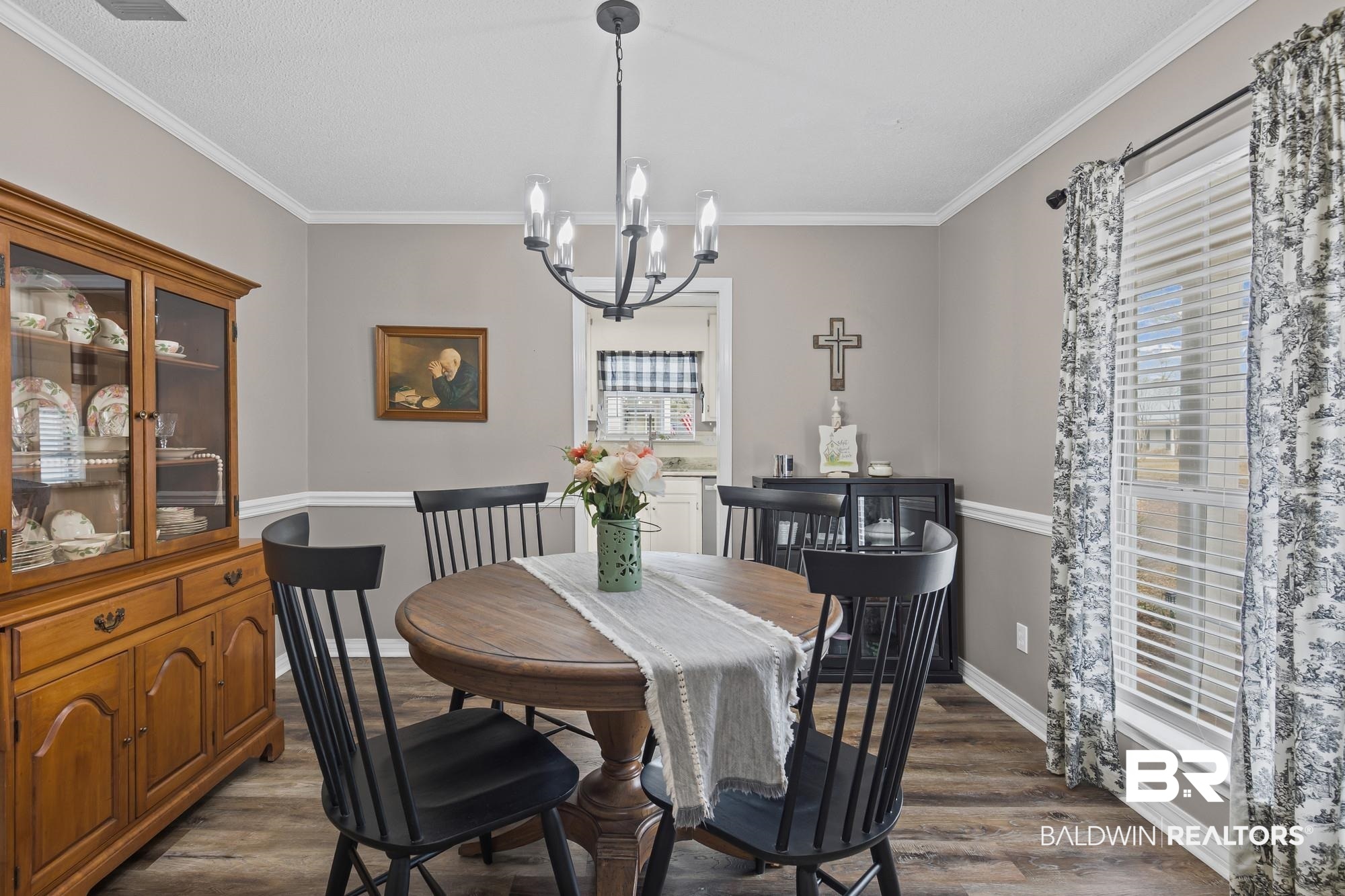 6609 Blakeley Court Mobile, AL 36695 - Photo 3 of 28 Dining space featuring dark wood finished floors, a chandelier, and ornamental molding