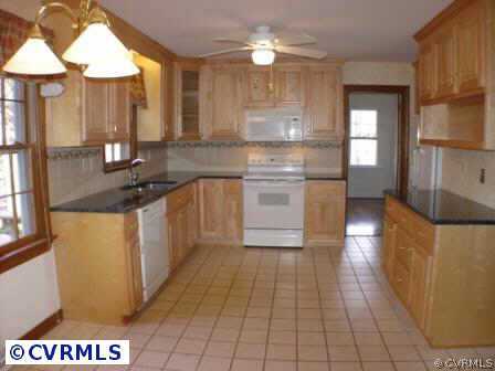 1930 Albion Road Midlothian, VA 23113 - Photo 7 of 10 a kitchen with a sink a refrigerator and cabinets