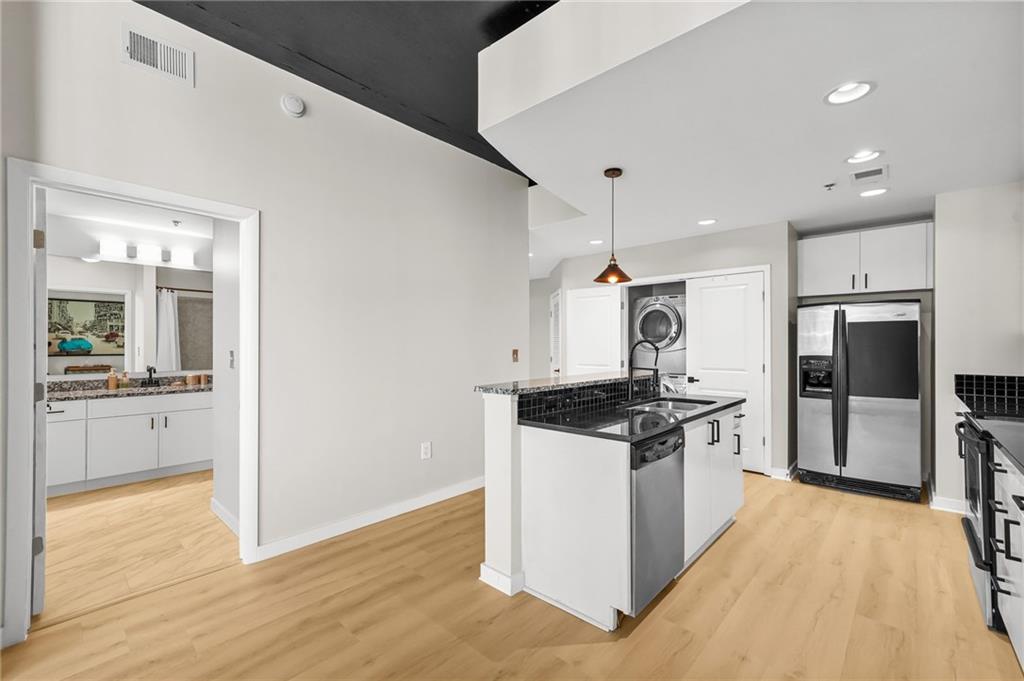250 Pharr Road Northeast, Unit 1702 Atlanta, GA 30305 - Photo 2 of 23 a kitchen with stainless steel appliances granite countertop a stove and a refrigerator