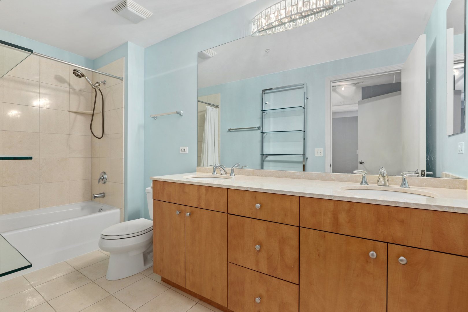 565 West Quincy Street, Unit 717 Chicago, IL 60661 - Photo 17 of 37 a bathroom with a double vanity sink toilet mirror and shower