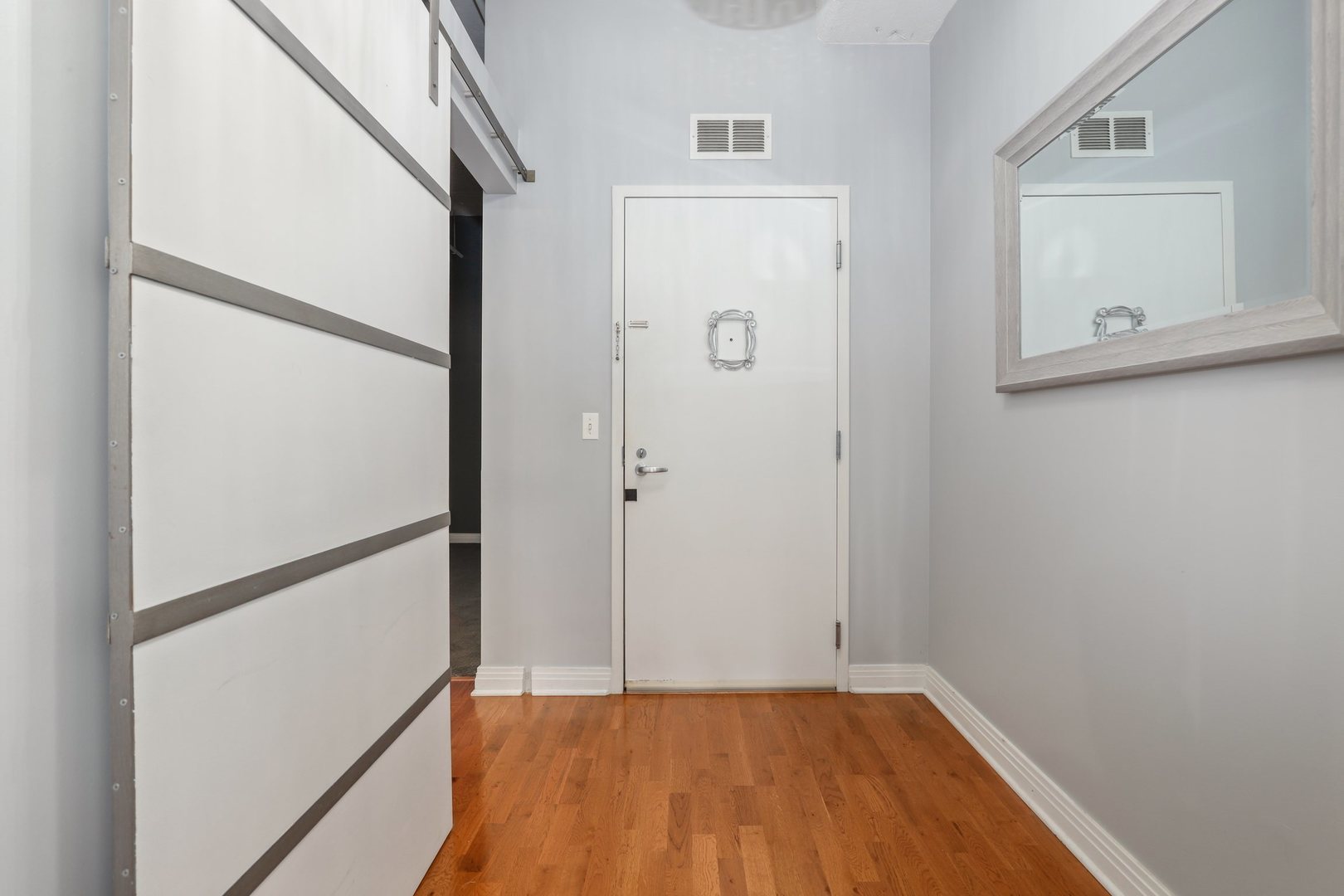 565 West Quincy Street, Unit 717 Chicago, IL 60661 - Photo 18 of 37 a view of a hallway with wooden floor