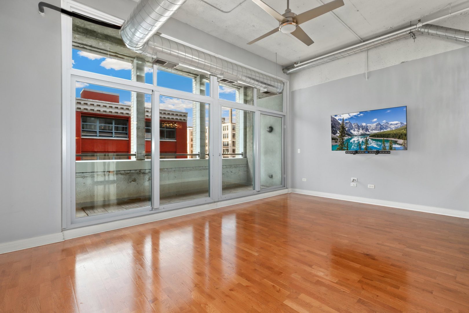 565 West Quincy Street, Unit 717 Chicago, IL 60661 - Photo 4 of 37 a view of empty room with wooden floor and fan