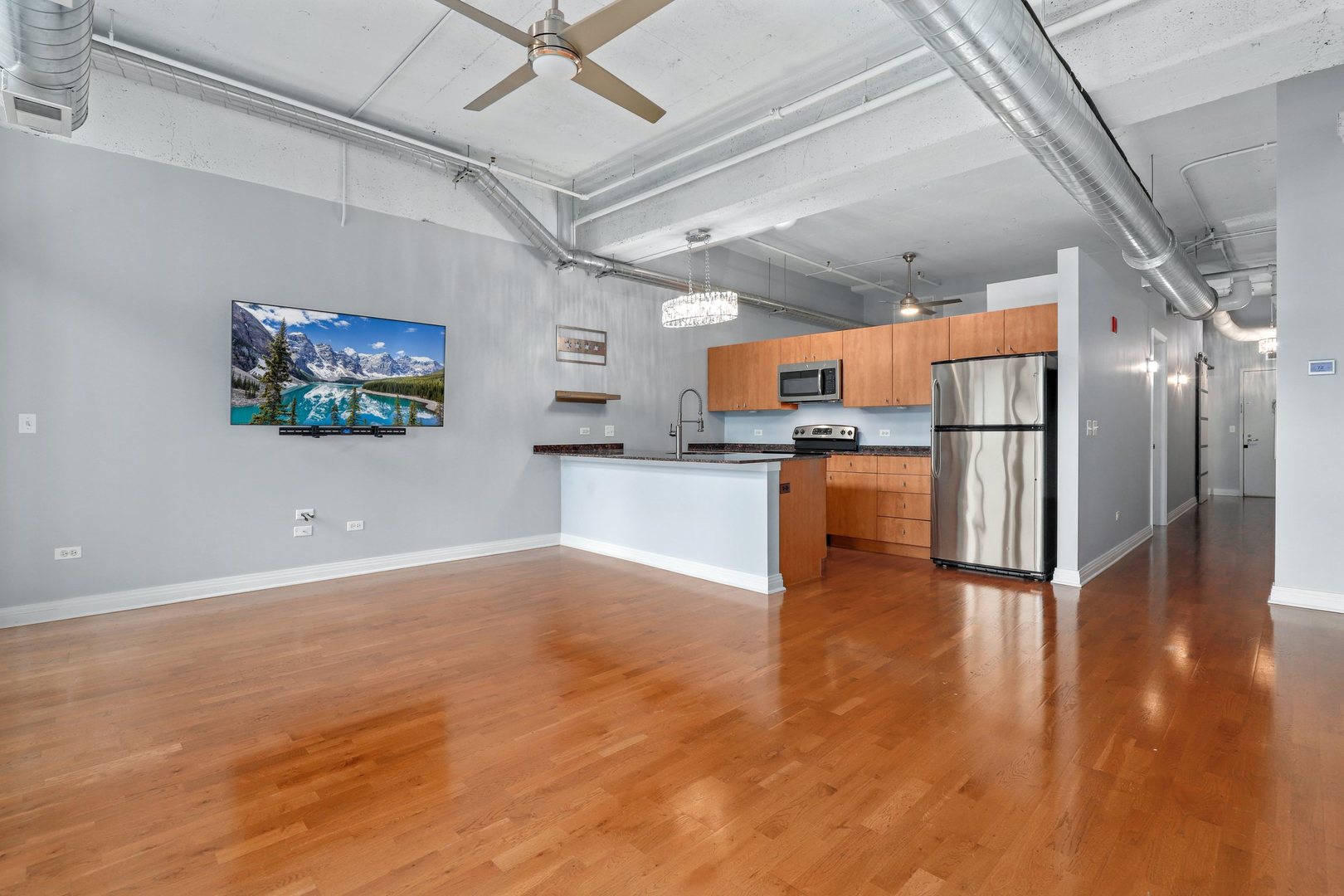 565 West Quincy Street, Unit 717 Chicago, IL 60661 - Photo 10 of 37 a kitchen with stainless steel appliances granite countertop a refrigerator and a stove top oven