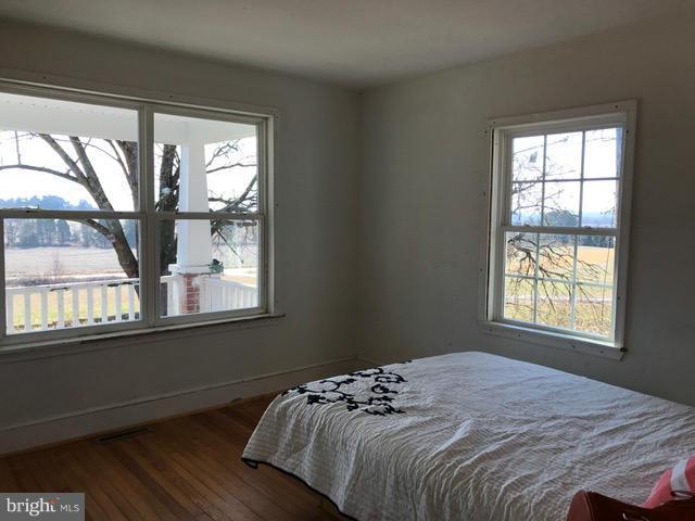 223 Forest Lane Road Fredericksburg, VA 22405 - Photo 11 of 15 a bed sitting in a bedroom next to a window