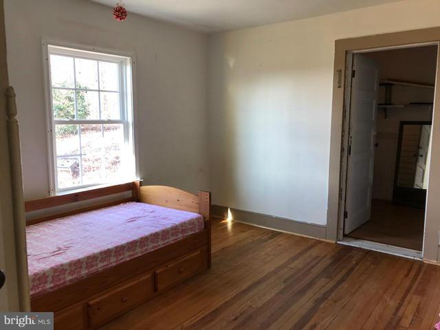 223 Forest Lane Road Fredericksburg, VA 22405 - Photo 10 of 15 a bed sitting in a bedroom next to a window