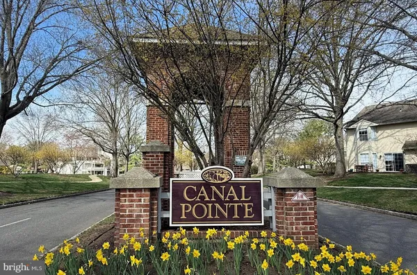 a street sign on a sidewalk next to a road