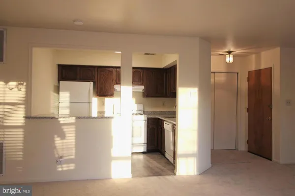 a kitchen with stainless steel appliances kitchen island granite countertop a refrigerator and a stove top oven