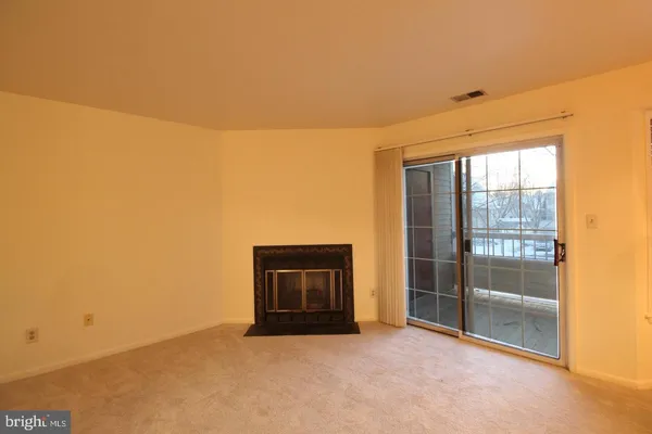 a view of an empty room with a fireplace
