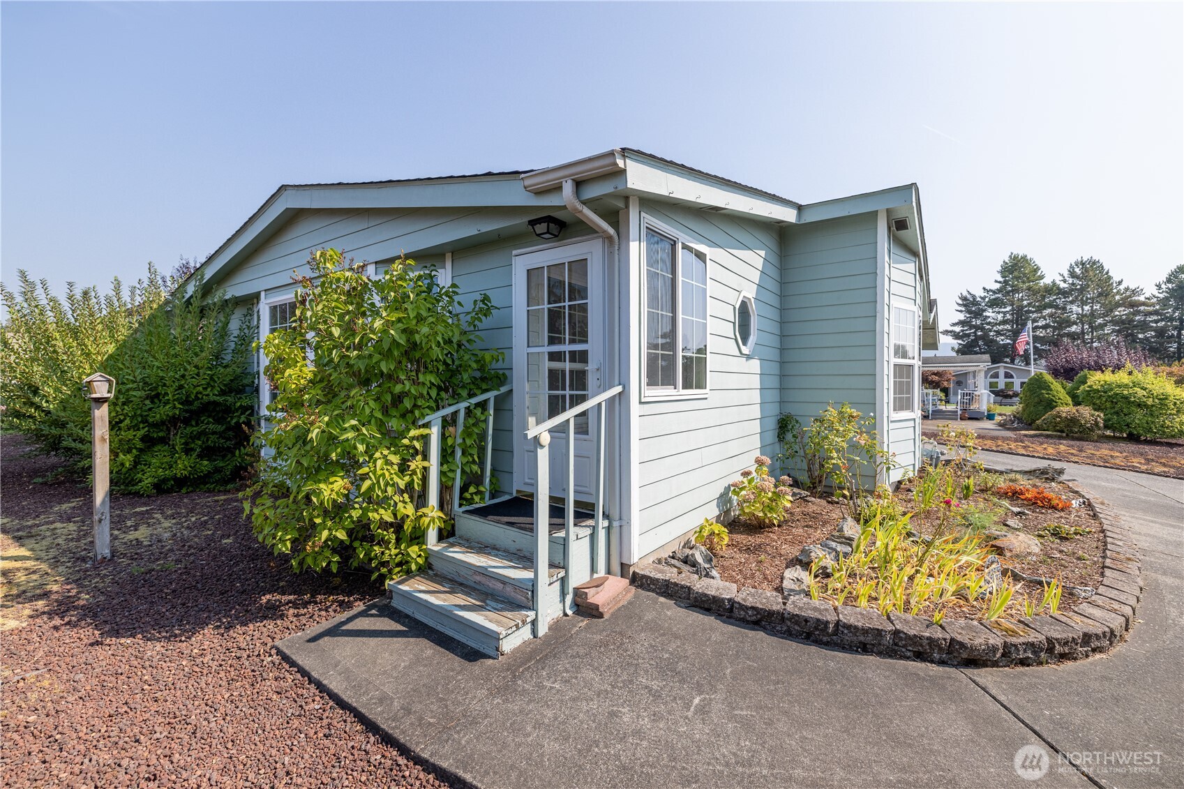 3802 James Street, Unit 82 Bellingham, WA 98226 - Photo 4 of 29 a view of a house with a small yard and potted plants