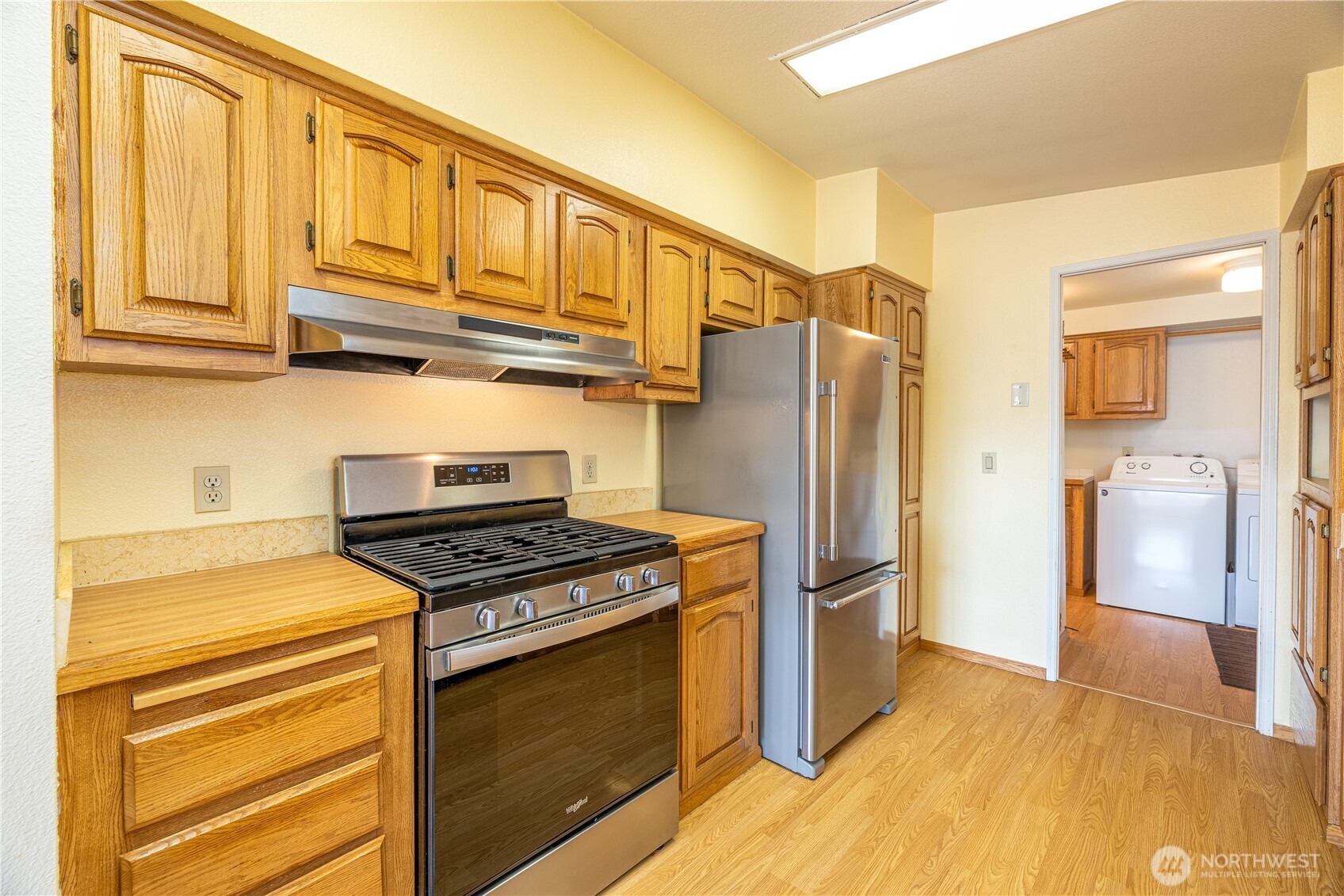 3802 James Street, Unit 82 Bellingham, WA 98226 - Photo 9 of 29 a kitchen with stainless steel appliances granite countertop a refrigerator and a stove top oven
