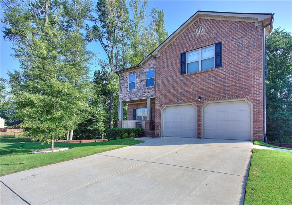 a front view of house with yard and green space