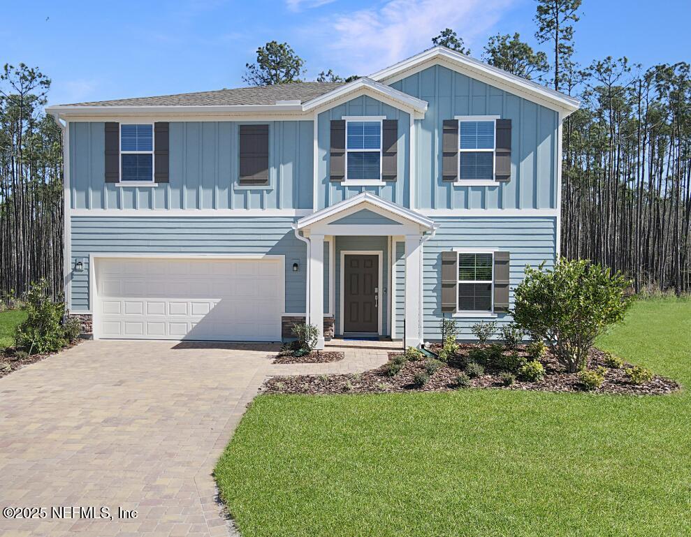 47 Bluegrass Way St. Augustine, FL 32092 - Photo 25 of 27 a front view of a house with a garden and yard