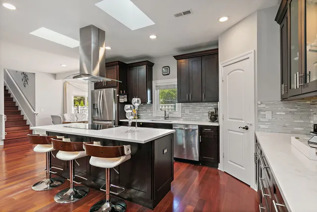 a kitchen with a table chairs sink and stove