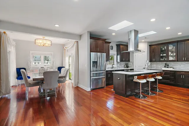 a large kitchen with a table and chairs in it