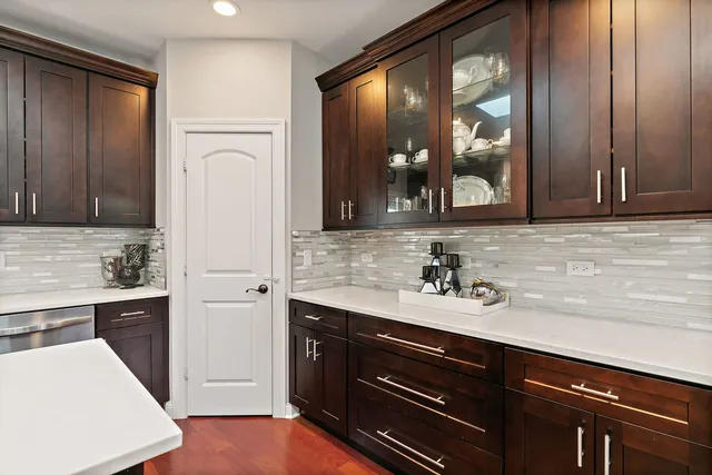 a view of a sink and a refrigerator in a kitchen