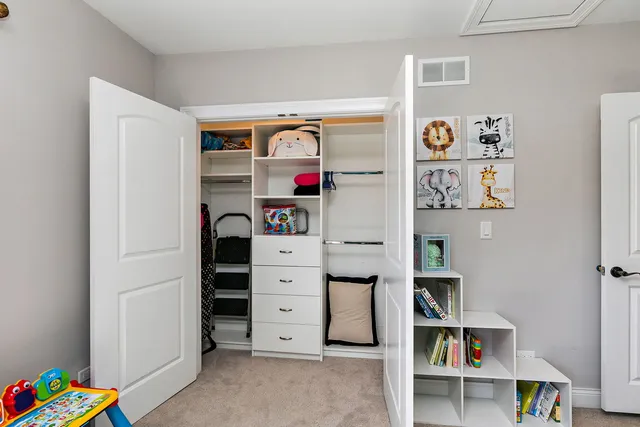 a view of walk in closet with clothes and shoes