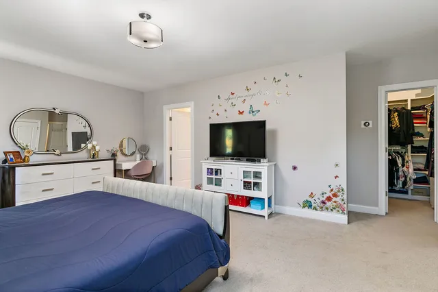 a bedroom with furniture and flat screen tv