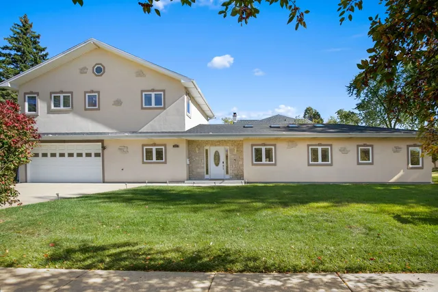 a view of a yard in front of a house with large trees