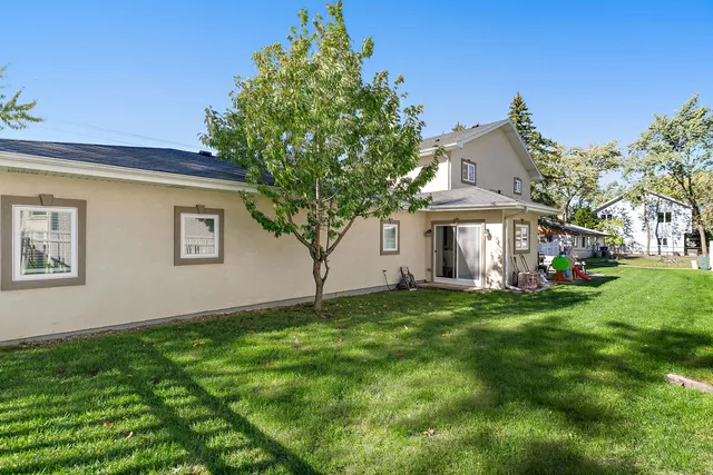 a view of a house with a yard and sitting area