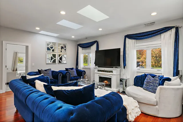a living room with fireplace furniture and a flat screen tv