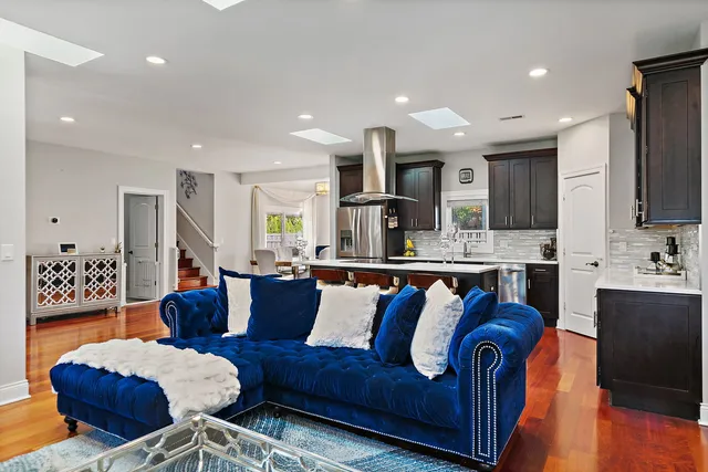 a living room with stainless steel appliances kitchen island granite countertop furniture and a view of kitchen