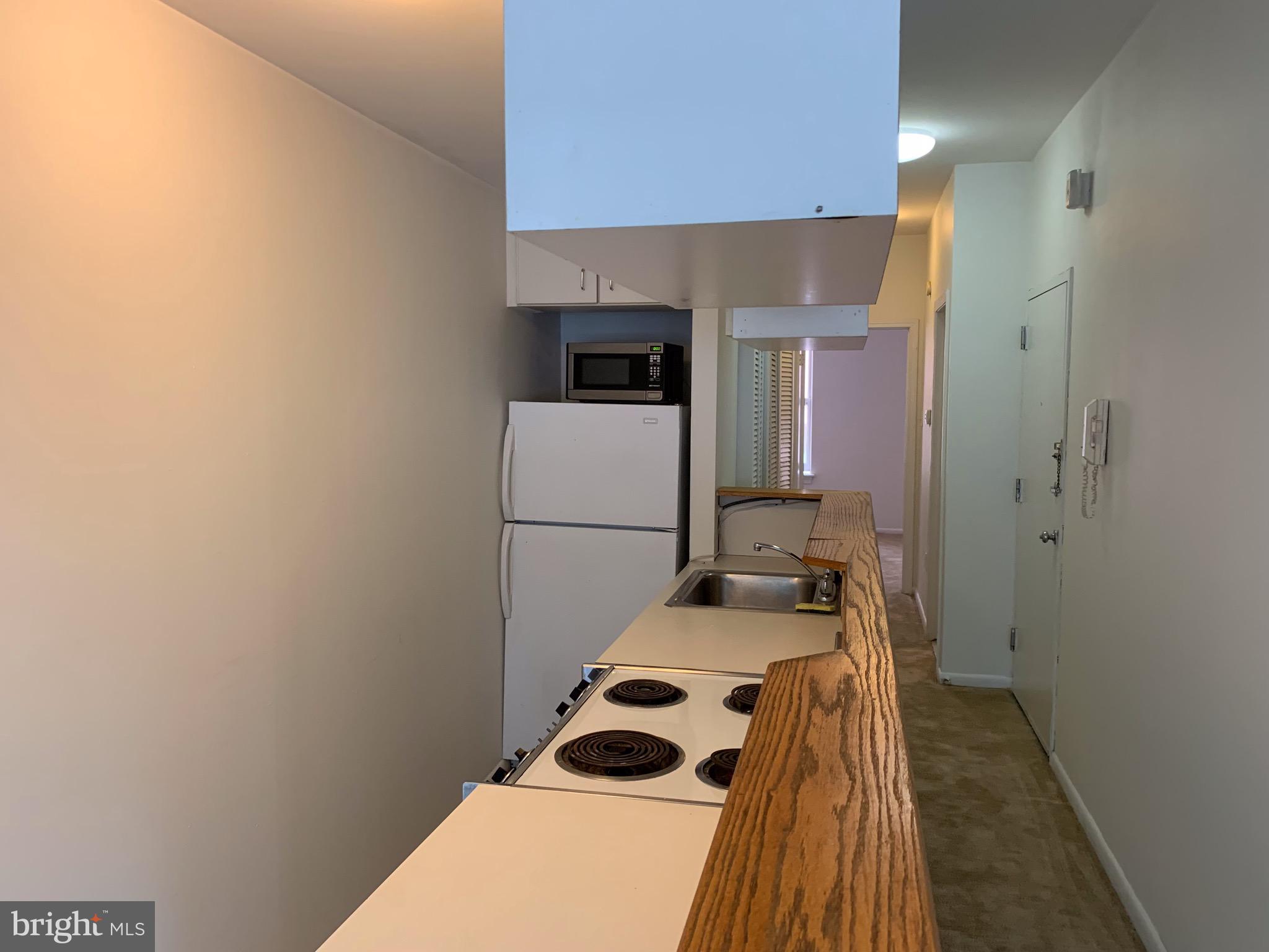 1203 Locust Street, Unit 2F Philadelphia, PA 19107 - Photo 6 of 15 a bedroom with a bed and cabinets