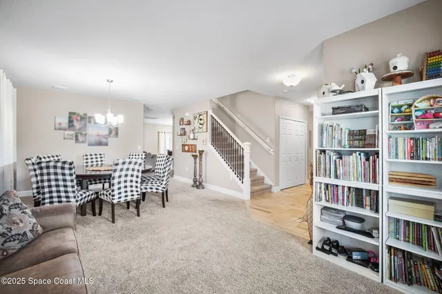 a living room with furniture and a book shelf