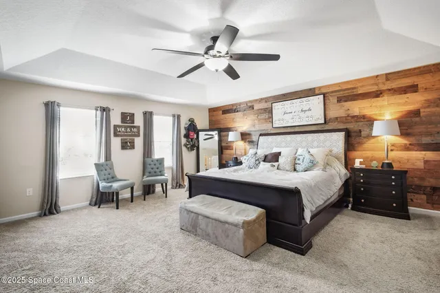 a bedroom with a bed and ceiling fan