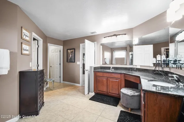 a large kitchen with kitchen island granite countertop a sink and cabinets