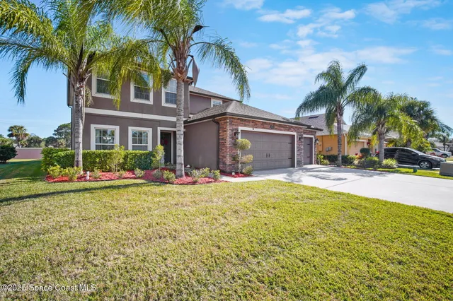 a view of a house with a swimming pool and a large tree
