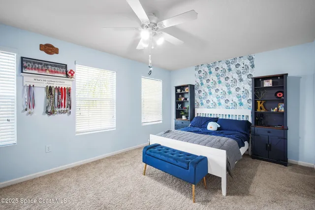 a bedroom with a bed dresser and a window