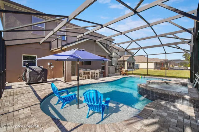 a view of swimming pool with outdoor seating