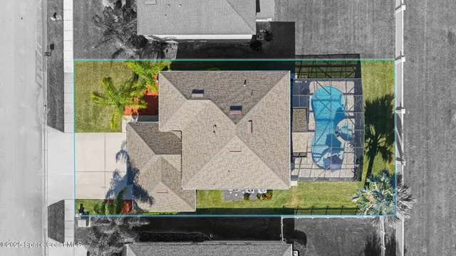an aerial view of a residential houses with outdoor space