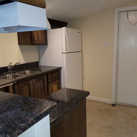 a kitchen with a sink and a refrigerator