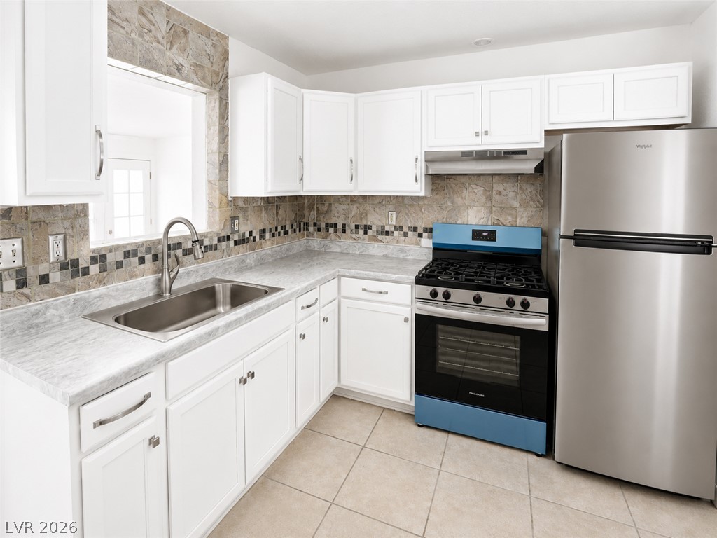 2870 South Sandhill Road Las Vegas, NV 89121 - Photo 27 of 64 A well-equipped kitchen features modern appliances and a convenient pass-through window.