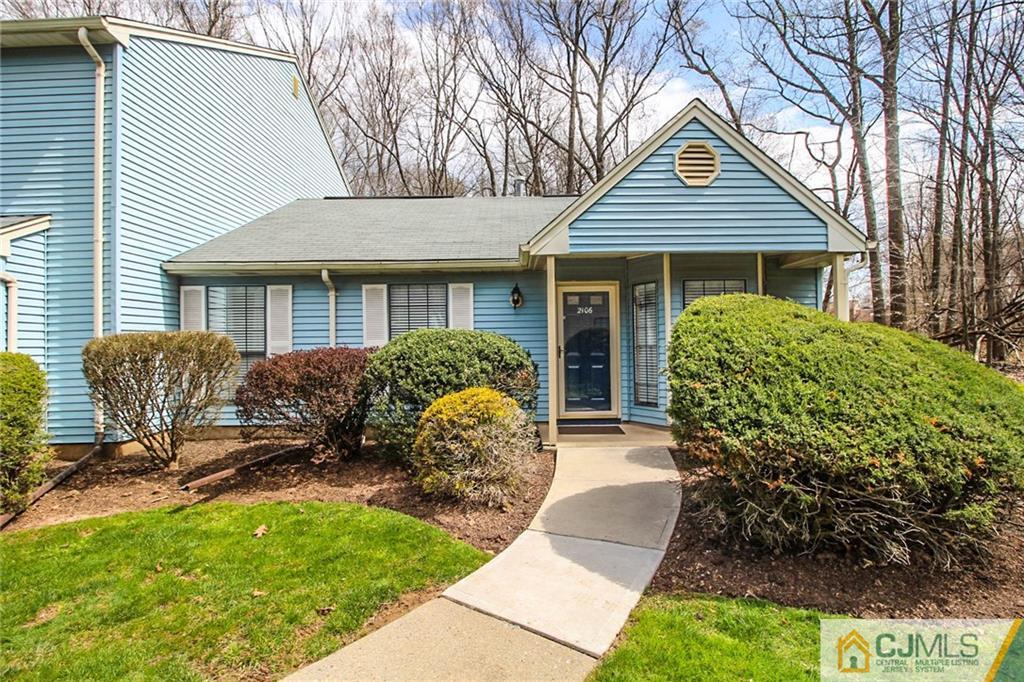 2106 Timber Oaks Road, Unit 2106 Edison, NJ 08820 - Photo 2 of 25 a front view of a house with garden