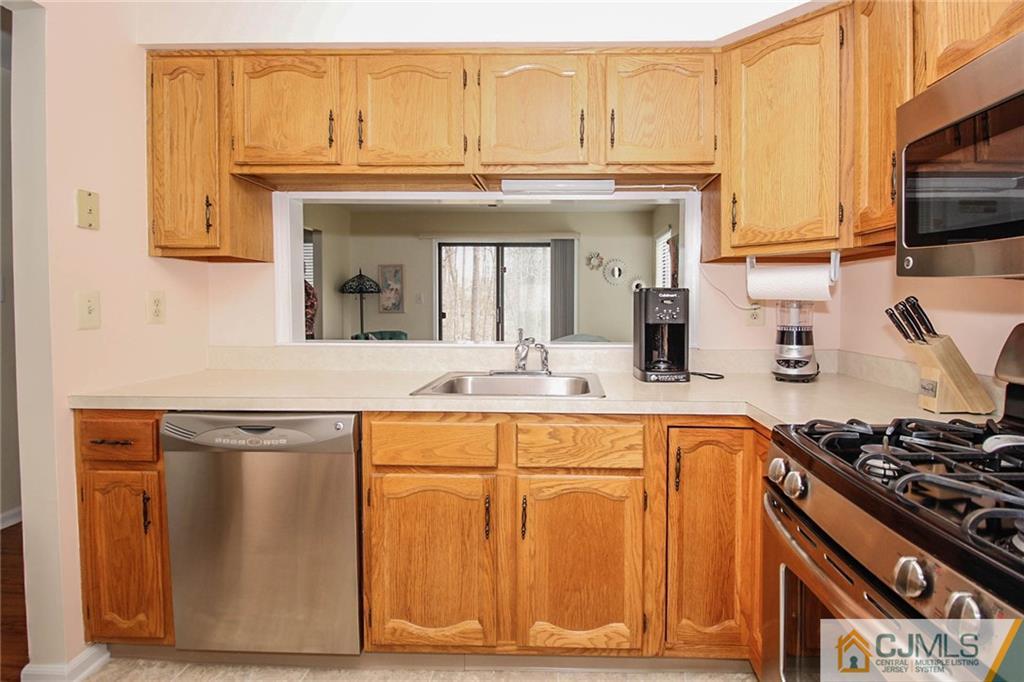 2106 Timber Oaks Road, Unit 2106 Edison, NJ 08820 - Photo 12 of 25 a kitchen with stainless steel appliances granite countertop a stove and a microwave