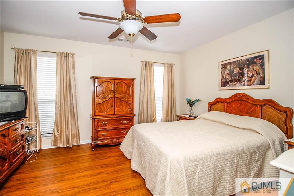 2106 Timber Oaks Road, Unit 2106 Edison, NJ 08820 - Photo 17 of 25 a bedroom with a bed and a flat screen tv