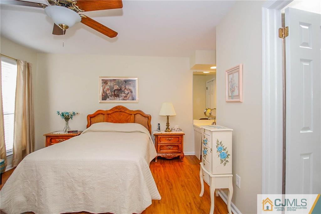 2106 Timber Oaks Road, Unit 2106 Edison, NJ 08820 - Photo 18 of 25 a bedroom with a bed and a painting on the wall
