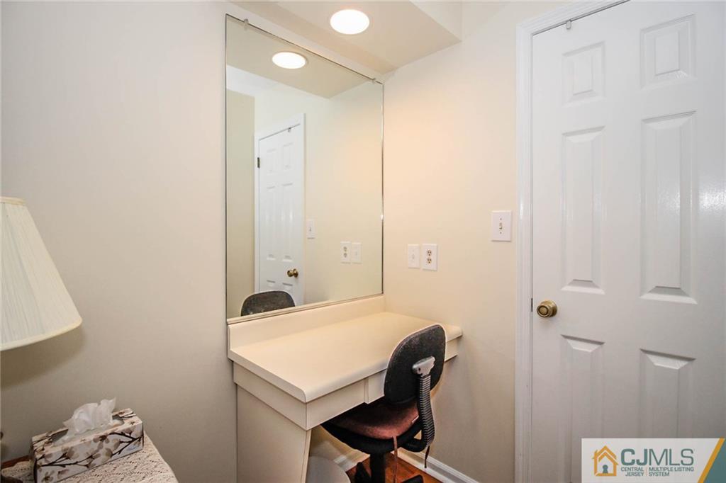 2106 Timber Oaks Road, Unit 2106 Edison, NJ 08820 - Photo 21 of 25 a bathroom with a sink a light fixture and a shower