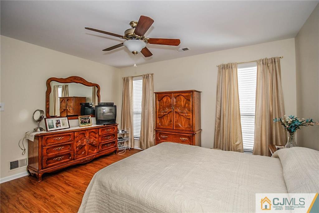 2106 Timber Oaks Road, Unit 2106 Edison, NJ 08820 - Photo 22 of 25 a bedroom with furniture and a window