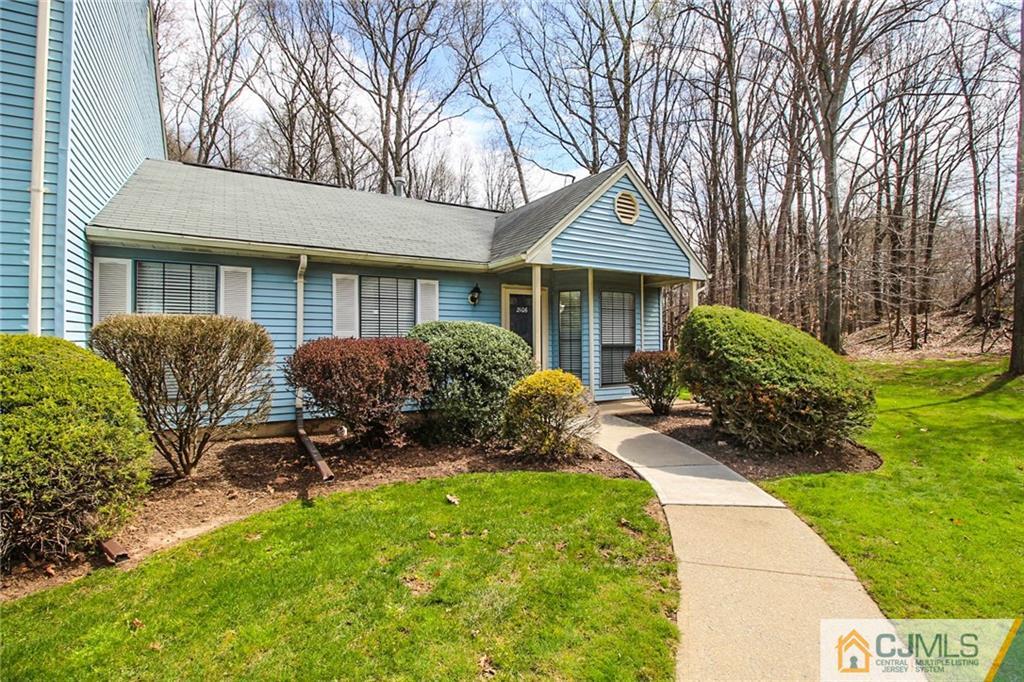 2106 Timber Oaks Road, Unit 2106 Edison, NJ 08820 - Photo 4 of 25 a view of a house with backyard sitting area and garden